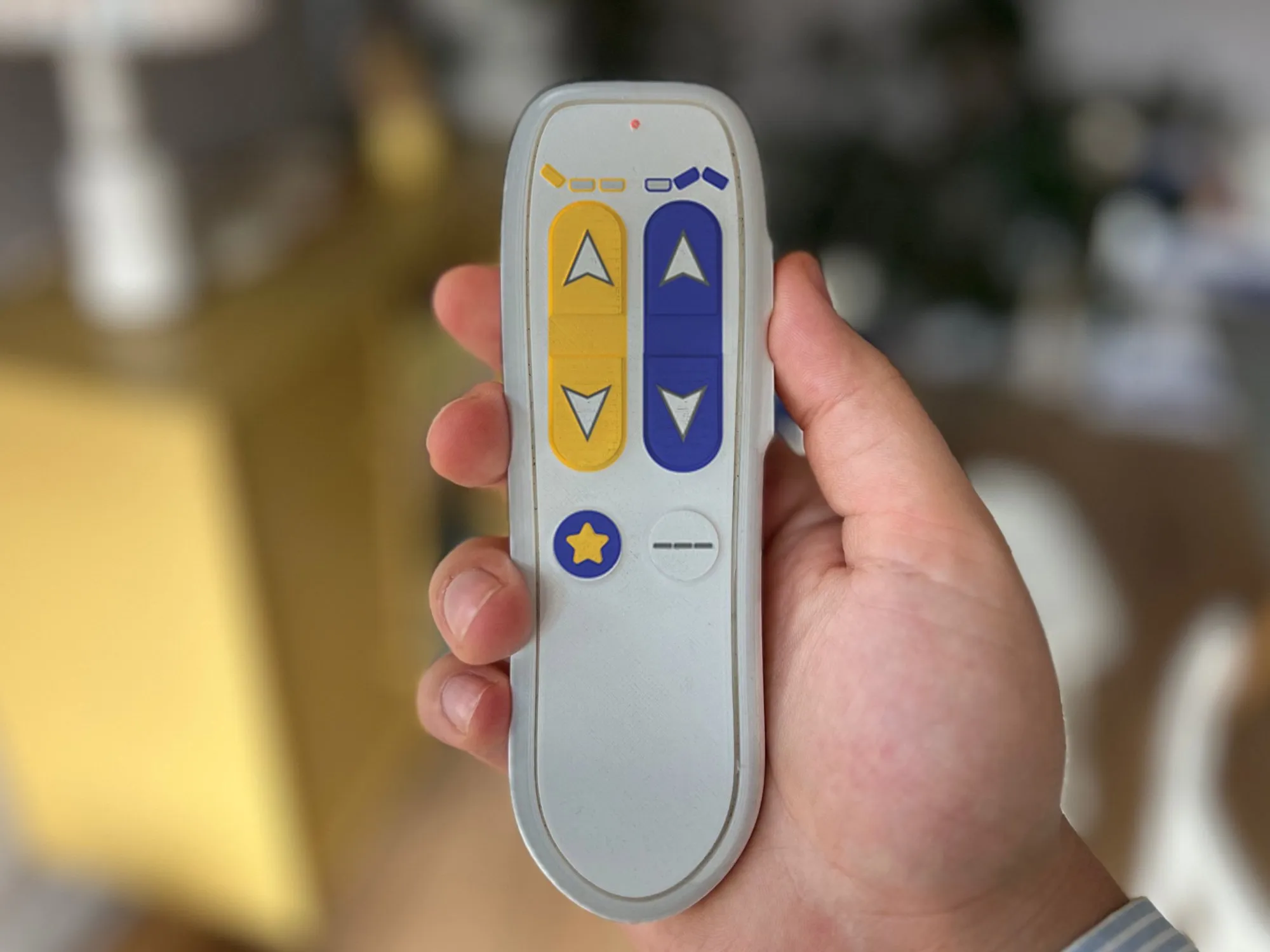 The 3D printed remote held in a hand